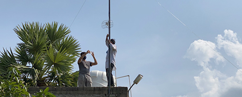 Two men setting up antena