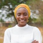 A headshot of a woman in a white shirt