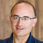 a man wearing glasses posing for a photo