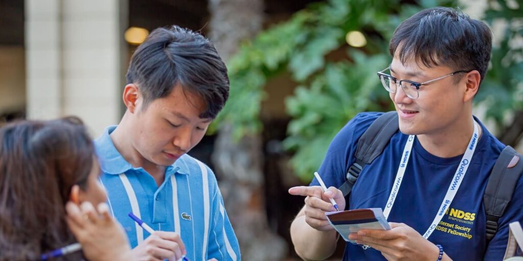Two men and a woman engaged in conversation.