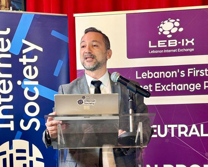 A man stands at a podium and speaks at a Lebanon Chapter event
