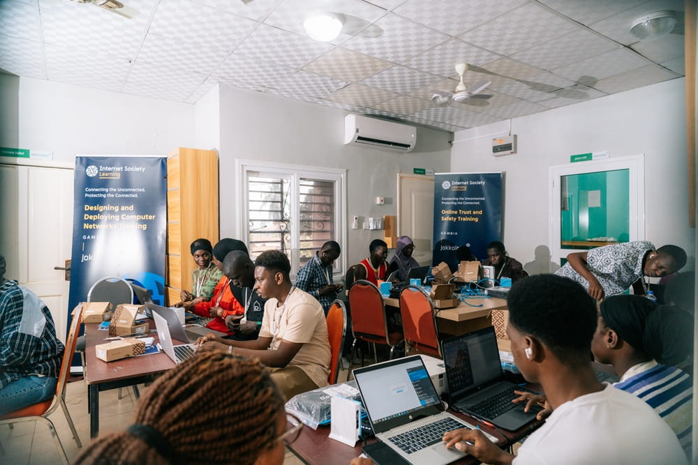 Young people at the classroom working on laptops